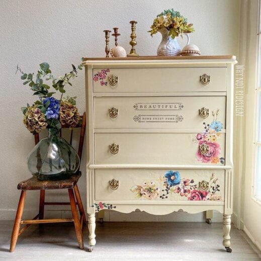 dresser painted in tan clay furntiure paint with flowers and a vase resting beside it