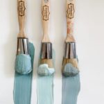 Three MudPaint brushes with shades of blue, gray and aqua clay furniture paint